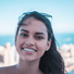 Woman smiling with sunglasses on head 